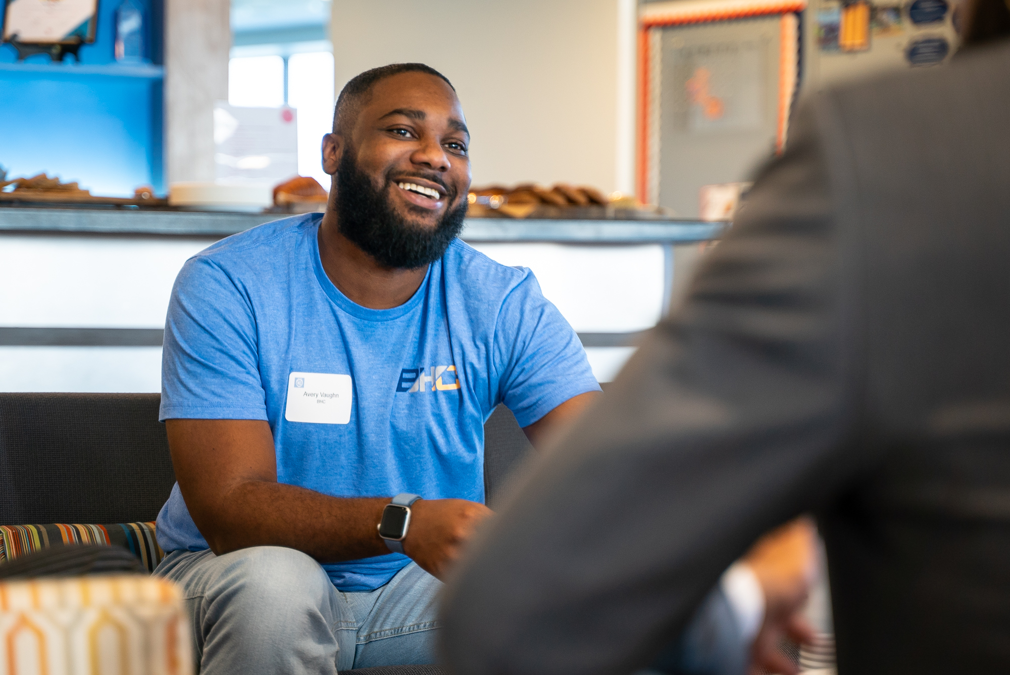 candid photo of attendee smiling and talking 